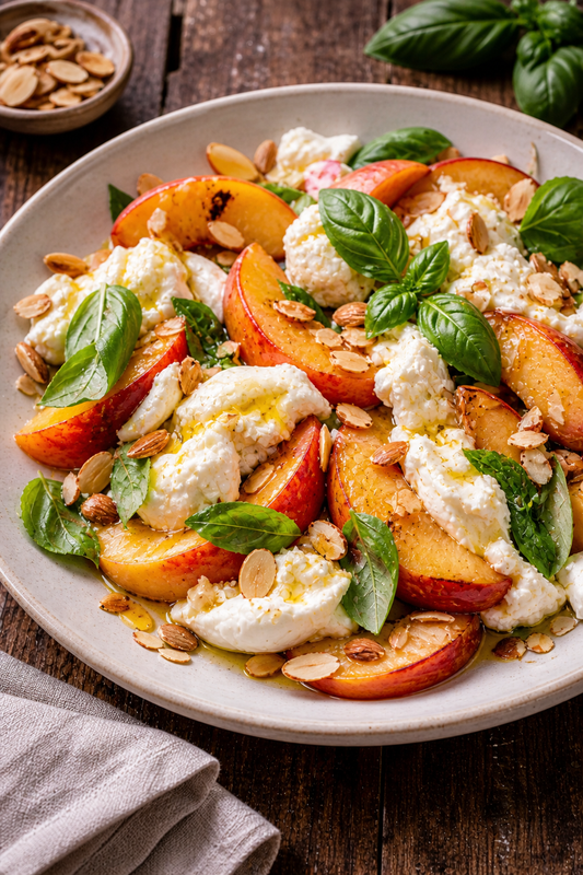 Peach, burrata and basil salad with toasted almonds