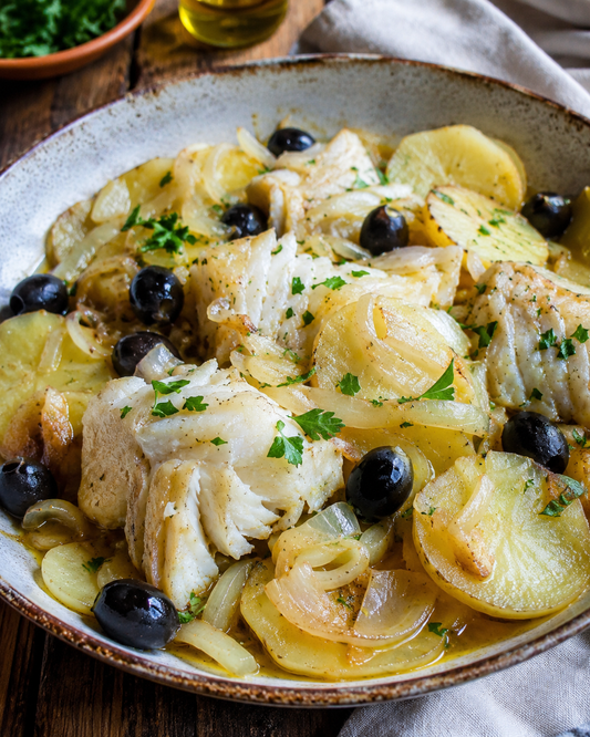 Portuguese-style baked salt cod with onions, olives and potatoes